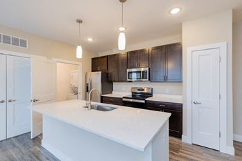 A kitchen with a large white counter top